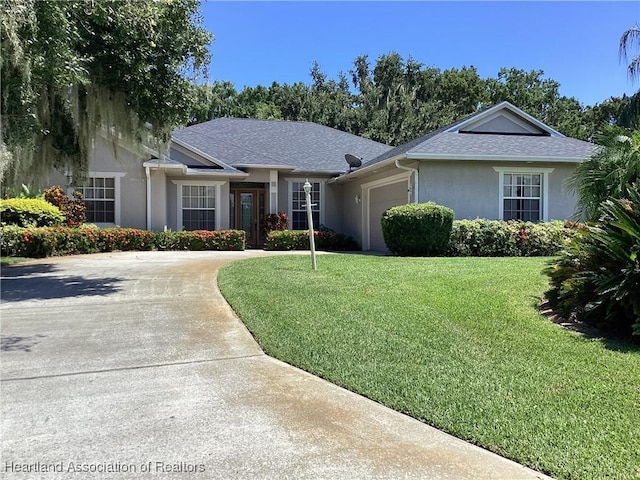 single story home with driveway, roof with shingles, an attached garage, a front lawn, and stucco siding