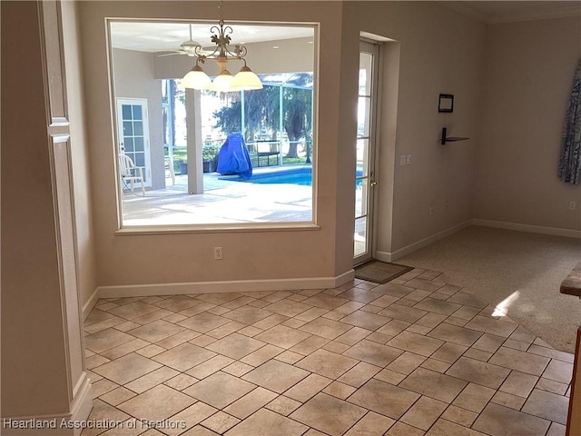 doorway to outside with a chandelier