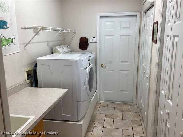 clothes washing area featuring washer and clothes dryer