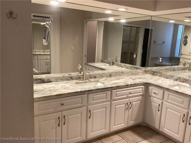 bathroom with tile patterned floors and vanity