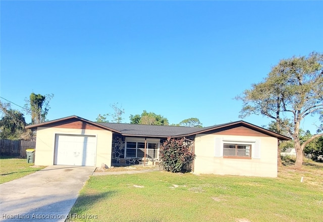 view of front of home featuring an attached garage, fence, a front lawn, and concrete driveway