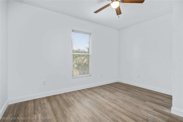 unfurnished room featuring ceiling fan and hardwood / wood-style flooring