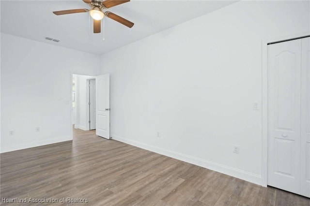 unfurnished room featuring ceiling fan and hardwood / wood-style floors