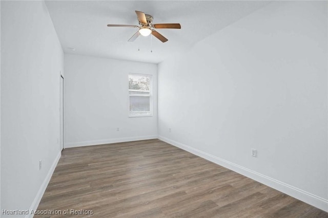 unfurnished room with ceiling fan and wood-type flooring