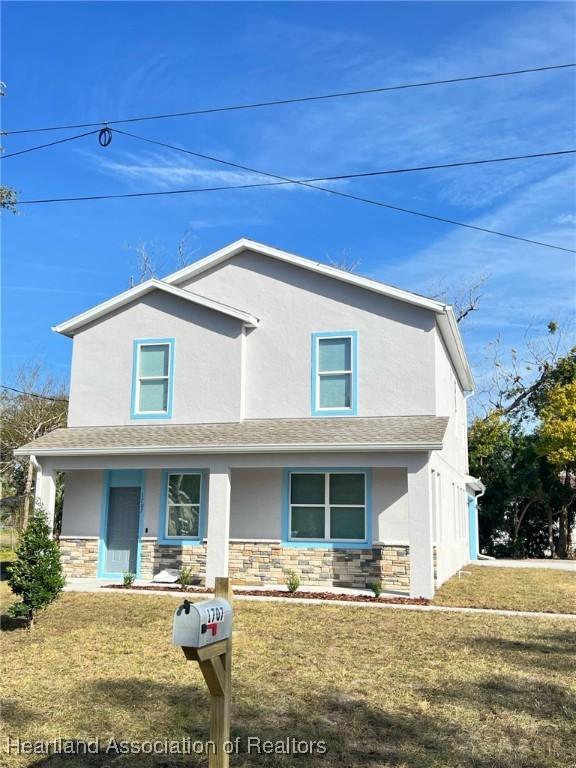 view of front property with a garage and a porch