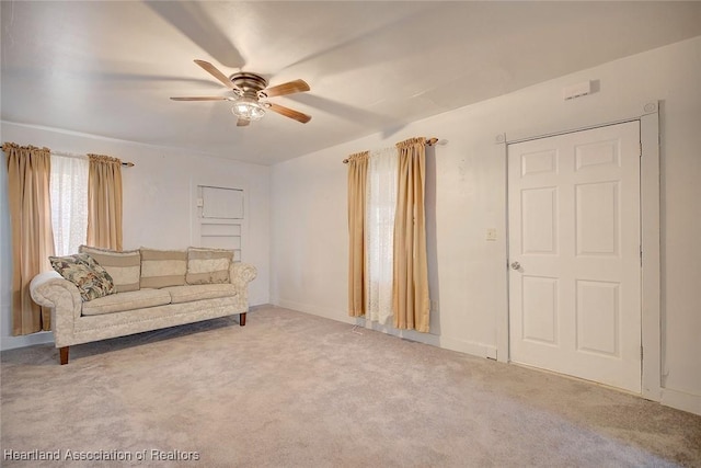 living room featuring carpet floors and ceiling fan