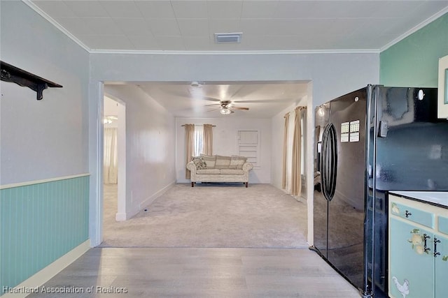 interior space featuring light hardwood / wood-style floors and crown molding