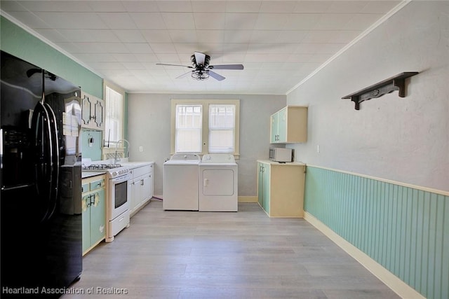 kitchen with ceiling fan, washing machine and dryer, white gas stove, light hardwood / wood-style floors, and black fridge with ice dispenser