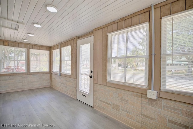 unfurnished sunroom with wood ceiling