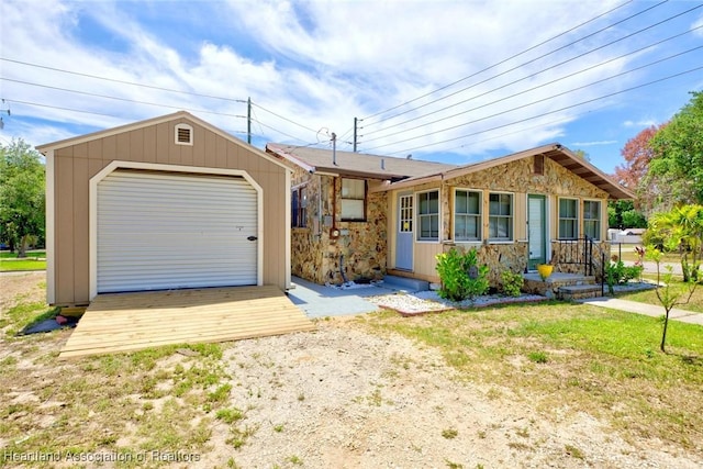 single story home featuring an outbuilding and a garage