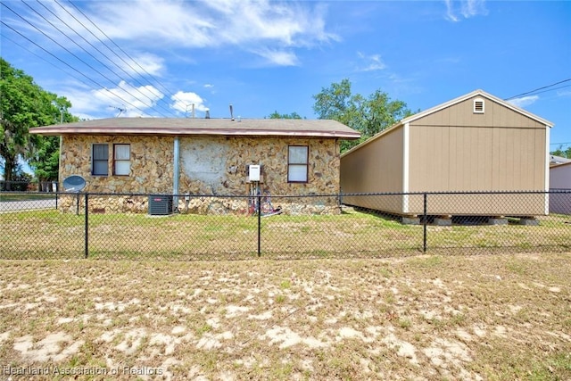 view of side of home with a yard and central AC