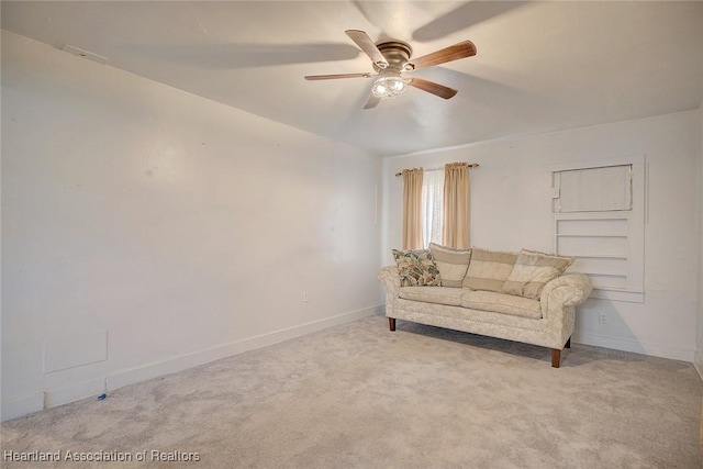 sitting room with ceiling fan and light colored carpet