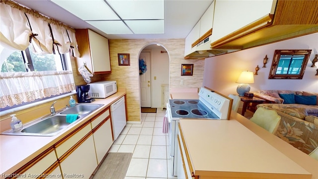 kitchen with white cabinetry, sink, white appliances, light tile patterned floors, and exhaust hood