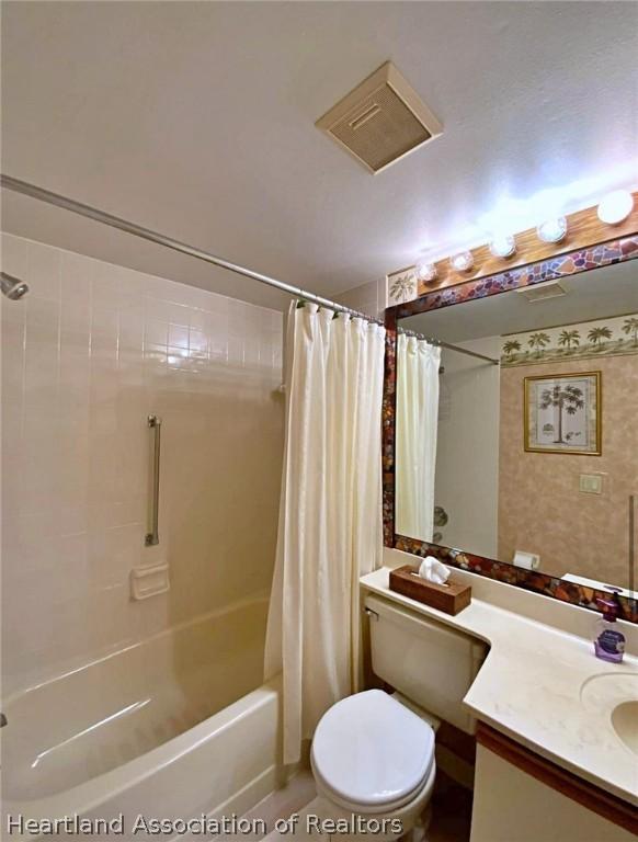 full bathroom featuring tile patterned flooring, vanity, shower / bath combination with curtain, and toilet