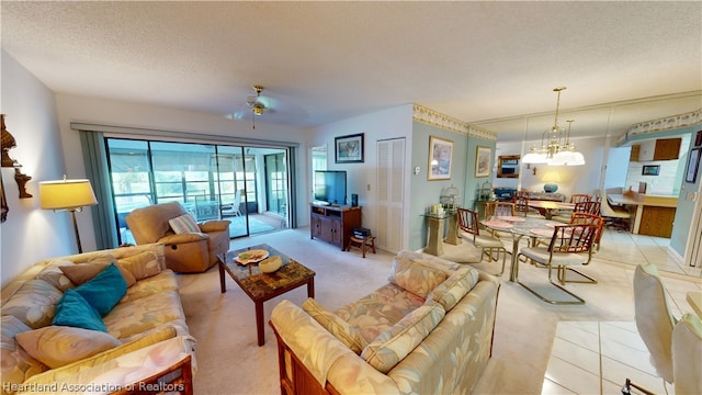 carpeted living room with ceiling fan with notable chandelier and a textured ceiling