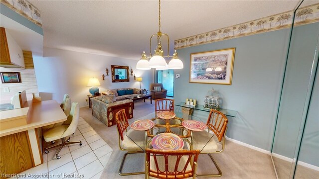 dining room featuring a notable chandelier and light tile patterned floors