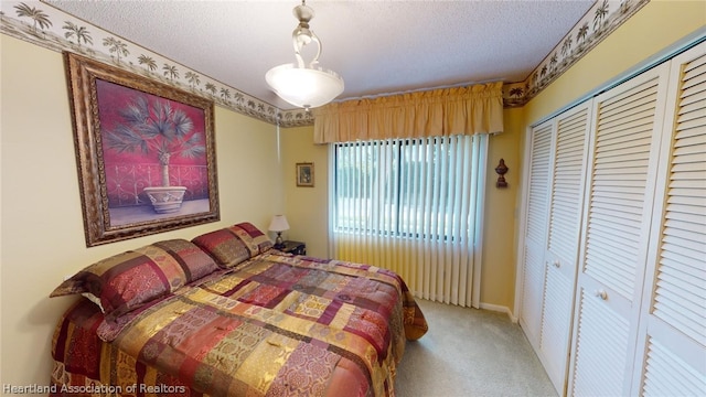 bedroom with light carpet, a textured ceiling, and a closet