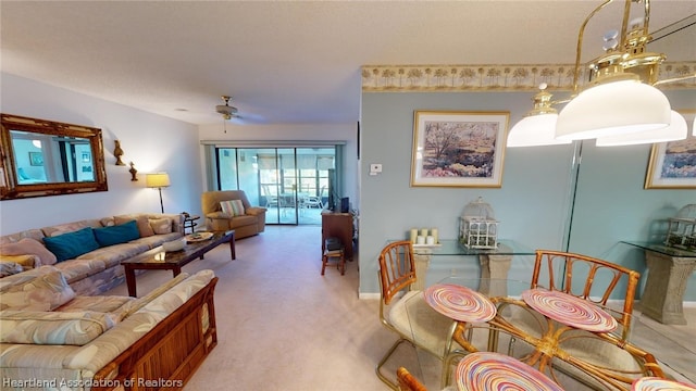 living room featuring ceiling fan and carpet