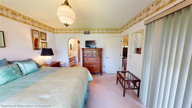 bedroom with carpet floors and a textured ceiling