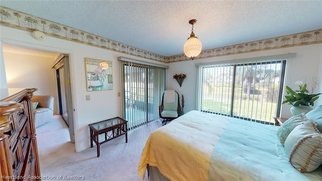 carpeted bedroom featuring access to exterior and a textured ceiling