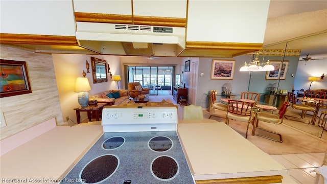 kitchen with ceiling fan with notable chandelier and hanging light fixtures