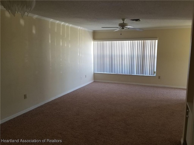 unfurnished room with a textured ceiling, visible vents, baseboards, a ceiling fan, and carpet