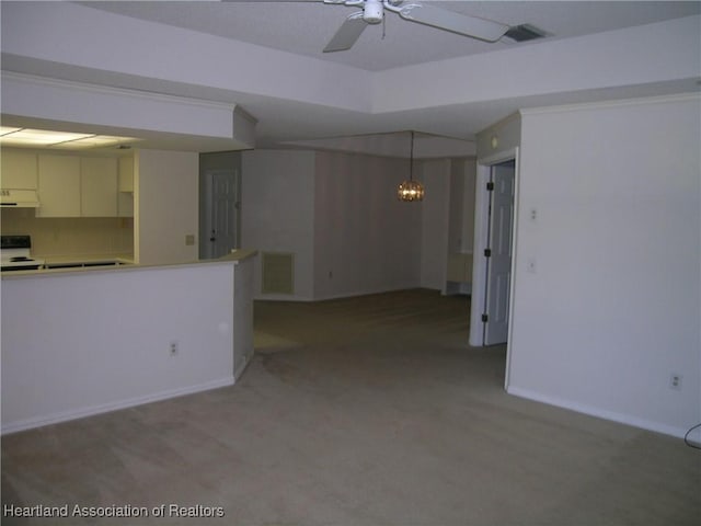 spare room featuring a ceiling fan, visible vents, light carpet, and baseboards