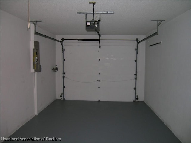 garage with electric panel and a garage door opener