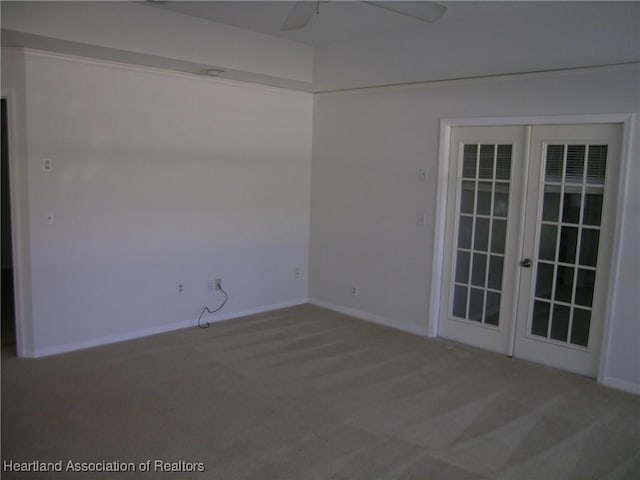 unfurnished room with baseboards, a ceiling fan, carpet flooring, and french doors