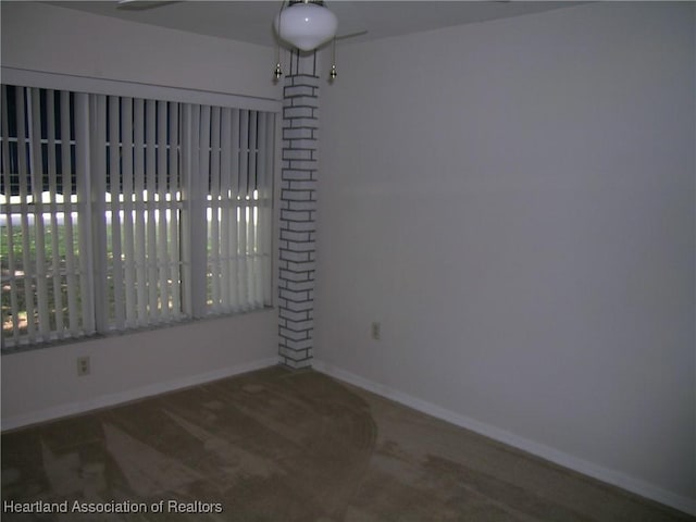 unfurnished room featuring baseboards