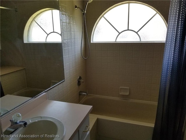 full bathroom featuring vanity, shower / bath combination with curtain, and a wealth of natural light