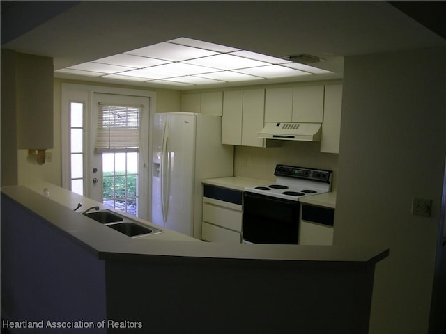 kitchen with white refrigerator with ice dispenser, electric range oven, a peninsula, under cabinet range hood, and a sink