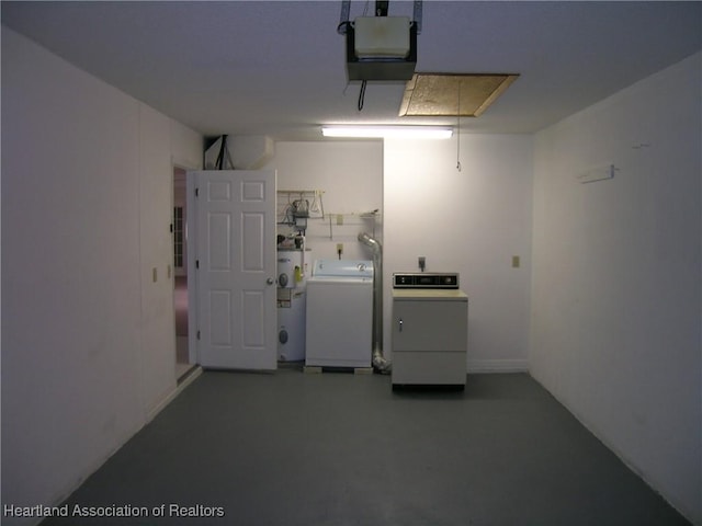 garage with electric water heater, washer / dryer, and a garage door opener