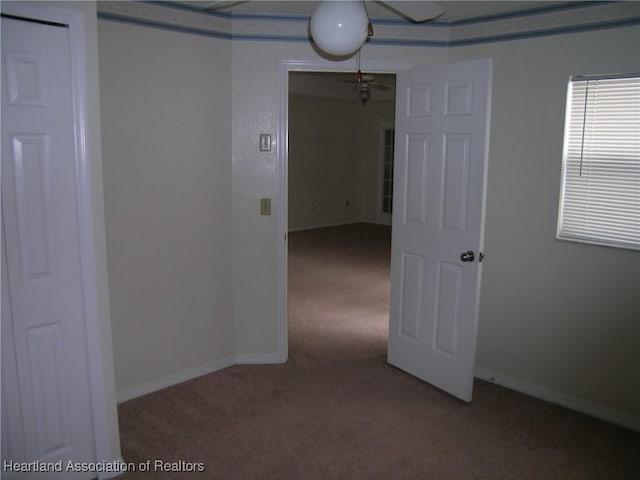 empty room with carpet floors and baseboards