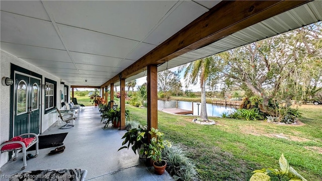 view of patio featuring a porch and a water view