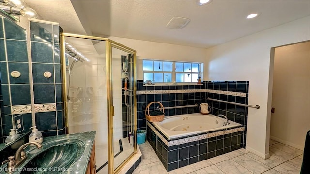 bathroom with vanity and shower with separate bathtub