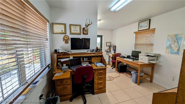 home office featuring a healthy amount of sunlight and light tile patterned floors