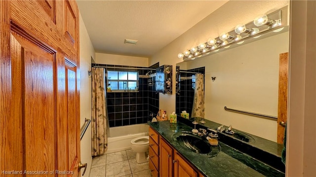 full bathroom featuring shower / bath combo, tile patterned floors, vanity, a textured ceiling, and toilet