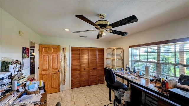 tiled office space featuring ceiling fan