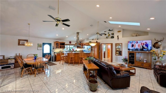 living room featuring a skylight, high vaulted ceiling, and ceiling fan