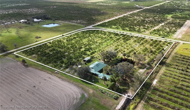 birds eye view of property with a rural view and a water view