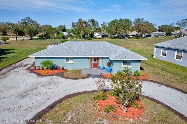 single story home featuring a front lawn