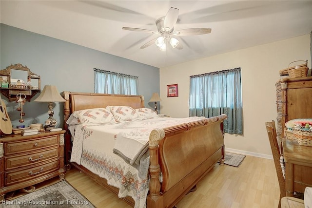 bedroom featuring multiple windows, light wood-type flooring, and ceiling fan