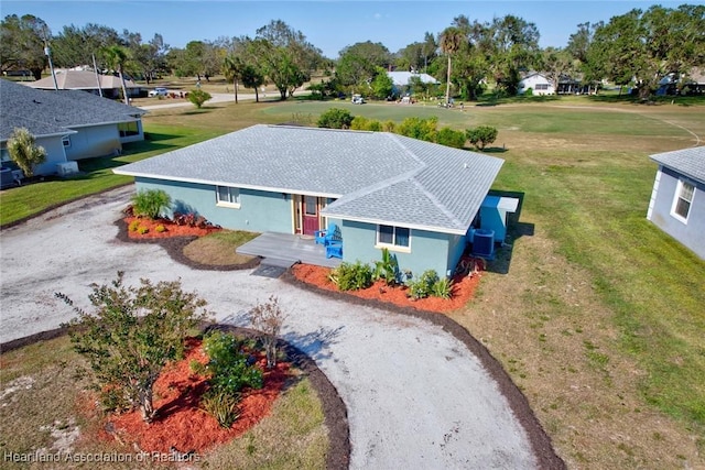 view of front of home featuring cooling unit and a front yard