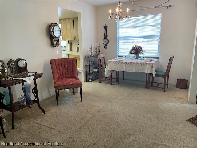 sitting room with light carpet and a notable chandelier