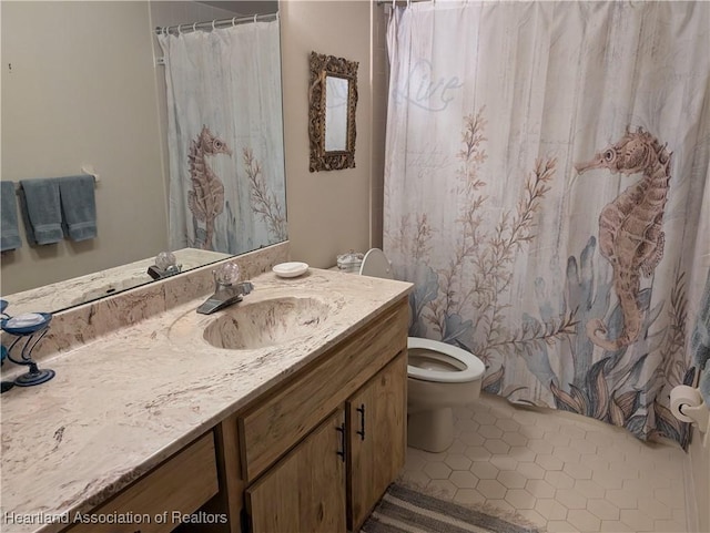 bathroom with toilet, vanity, tile patterned floors, and curtained shower