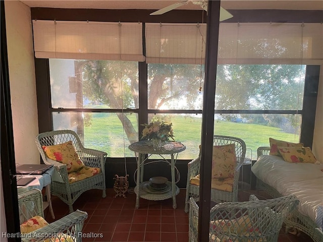 sunroom / solarium featuring ceiling fan