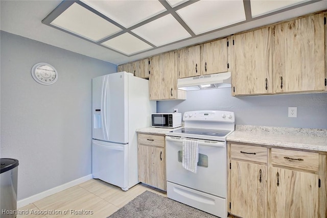 kitchen with light brown cabinets and white appliances