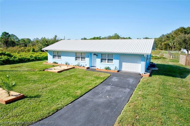 ranch-style home with a garage and a front yard