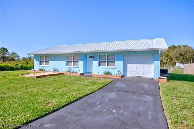 single story home with a front yard and a garage